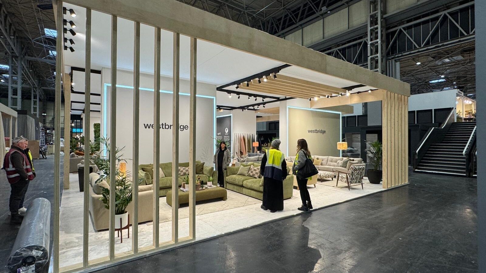 Marketing team examining a partially completed exhibition stand during installation